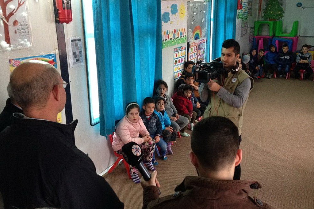A Christian TV broadcaster interviewing Wilson inside the ADRA learning center. (Andrew McChesney / AR)
