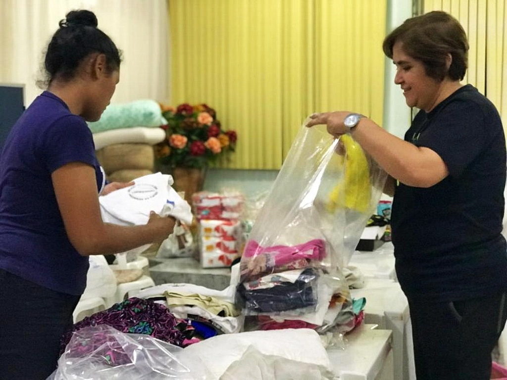 Адвентистские волонтеры помогают сортировать одежду, чтобы распределить ее среди пострадавших от пожара 17 декабря в Манаусе, Амазонасе, Бразилия. [Фотография: Новости Южно-Американского дивизиона]